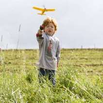  A boy flying the yellow plane