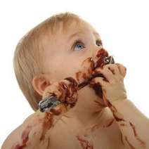  Baby eating chocolate with a spoon
