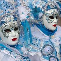  Two women wearing white-blue carnival costumes