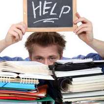  Man holding Help sign over a pile of books