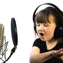  Small girl singing to a studio microphone