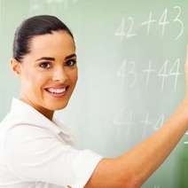 Woman writing on a chalkboard 