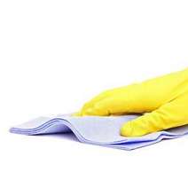  Hand in yellow rubber glove cleaning with a blue cloth