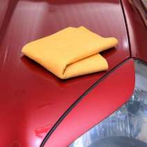 Cloth on a red car bonnet