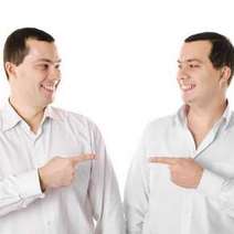 Twin brothers pointing at themselves 