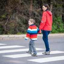 Mother and son crossing a road