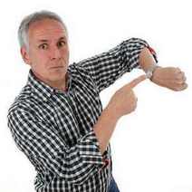  A man pointing at his watch