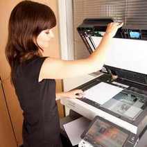  Woman using copying machine
