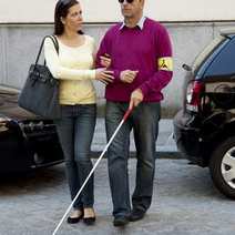  A woman leading a blind man