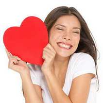  Young woman smiling with a big red heart