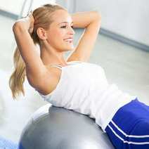  A woman exercising abs on a fit ball