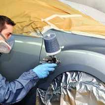 Man waxing a front fender of a car