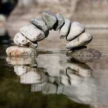  Small bridge made of stones on the water