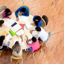 Kids sitting around a table and writing