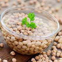 Lentils soaked in water in a plastic container