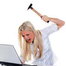 Woman hitting her computer with hammer