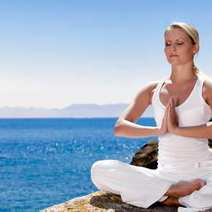  A woman meditating or exercising yoga
