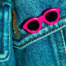 Pink kids glasses on jeans