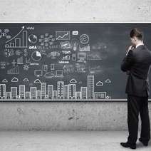  A man in front of charts on a chalkboard