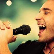  A man singing to a microphone