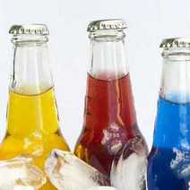  Three glass bottles of coloured lemonade