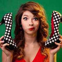 A woman holding dotted shoes