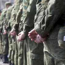 Soldiers with their hands at their backs