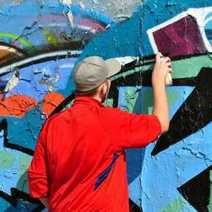 A guy painting some graffiti