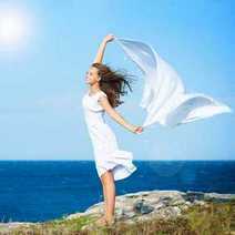 A girl on a cliff waving a white scarf