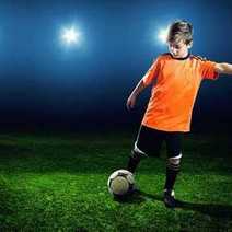 A kid kicking a soccer ball