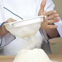 Somebody sieving flour
