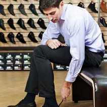 A guy trying shoes in a shoe store