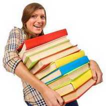 A girl carrying a stack of books