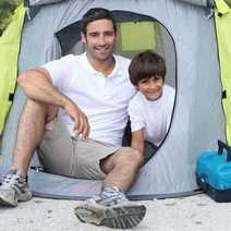 A dad and son in a tent