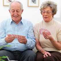 Some elderly people playing cards