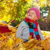 A little kid fallen in the leaves