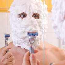  A man having a shaving foam all over his face