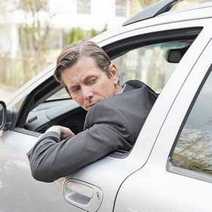 A man leaning out of a car