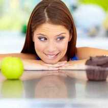 A girl looking at apple and cake