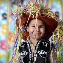 A little kid wearing a cowboy costume