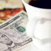 Dollar bank note next to the cup of coffee
