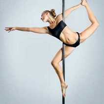 A woman in black underwear performing pole dance