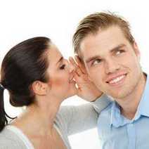  A woman whispering to man's ear