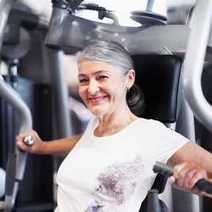 Smiling old lady in a fitness studio