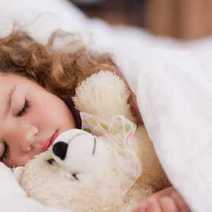  Little girl sleeping with her toy dog