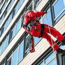  Window cleaner hanging on a rope
