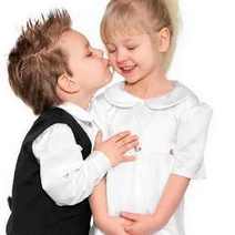  Little boy kissing little girl on a cheek
