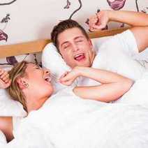  Young couple waking up in bed
