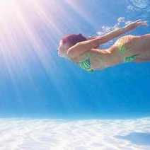  A woman swimming under water surface