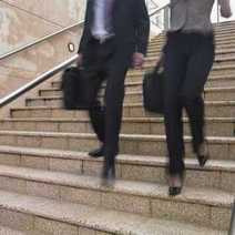 A man and a woman going down the stairs